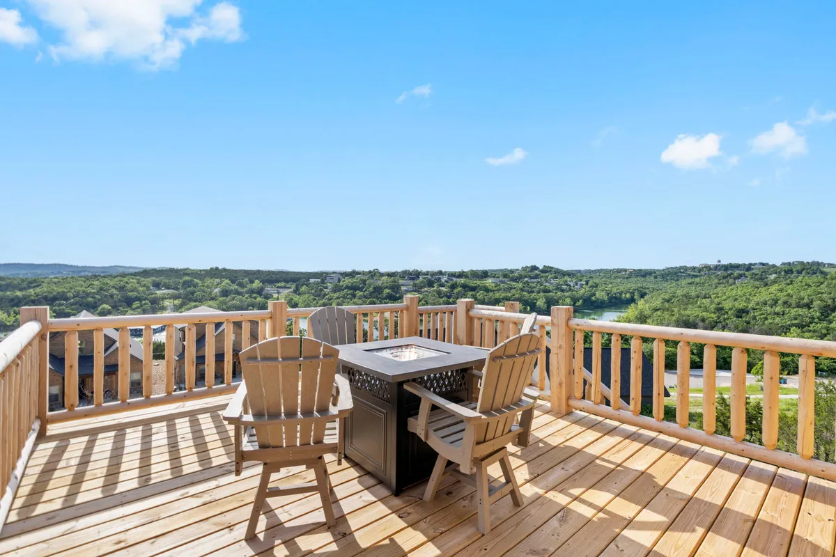 A welcoming outdoor seating area surrounds a fire pit, set against a panoramic landscape view. The setup invites guests to relax, entertain, and savor the outdoors, whether hosting a barbecue or stargazing by the fire.
